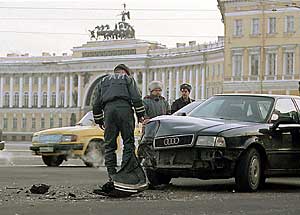 Fender Bender. A traffic police officer inspecting the damage done to 
          an Audi automobile that was involved in a traffic collision near where Nevsky Prospect meets Palace Square. SERGEY GRACHEV/SPT